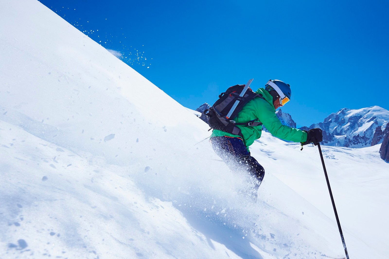 mature male skier speeding downhill on mont blanc massif, graian alps, france